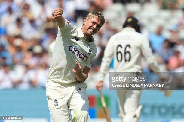 England's Olly Stone celebrates taking the wicket of New Zealand's Daryl Mitchell during play on the third day of the second Test cricket match...