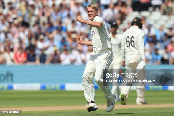 England's Olly Stone celebrates taking the wicket of New Zealand's Daryl Mitchell during play on the third day of the second Test cricket match...