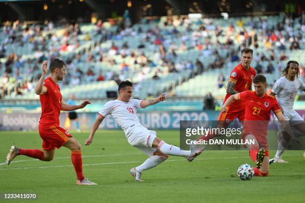 Wales' defender Chris Mepham vies for th eball with Switzerland's forward Mario Gavranovic during the UEFA EURO 2020 Group A football match between...