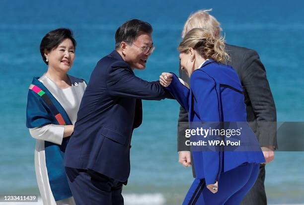 Britain's Prime Minister Boris Johnson and his spouse Carrie Johnson greet South Korea's President Moon Jae-in and First Lady Kim Jung-sook during an...