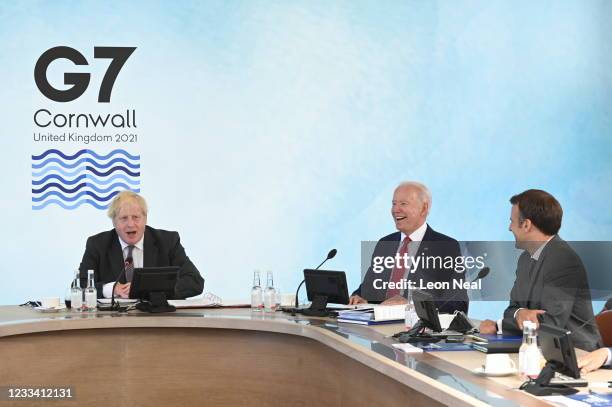 British Prime Minister Boris Johnson talks next to US President Joe Biden and French President Emmanuel Macron at the G7 summit in Carbis Bay on June...