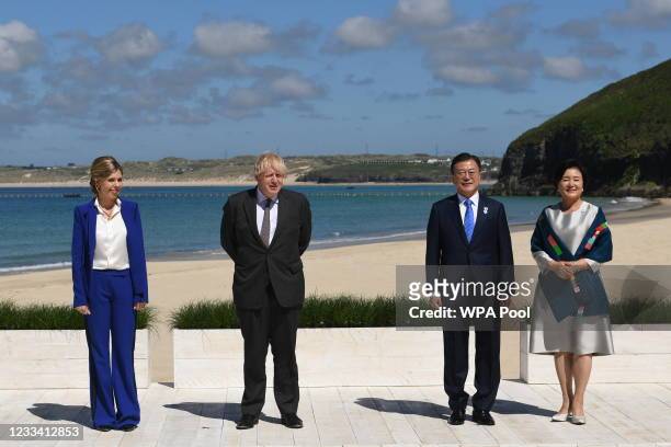 Britain's Prime Minister Boris Johnson and his spouse Carrie Johnson stand alongside South Korea's President Moon Jae-in and First Lady Kim Jung-sook...