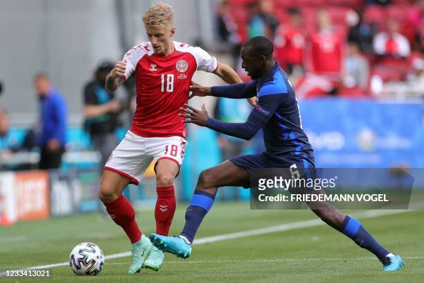 Denmark's defender Daniel Wass challenges Finland's midfielder Glen Kamara during the UEFA EURO 2020 Group B football match between Denmark and...