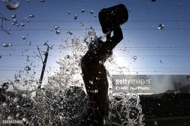 Man Bathes to cool off from heat amid the boiling hot day in Ajmer in the Indian state of Rajasthan on 12 June 2021.