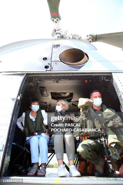 French Seas Minister Annick Girardin and French Ecological Transition Minister Barbara Pompili speak in an helicopter, in Sari-Solenzara, on the...