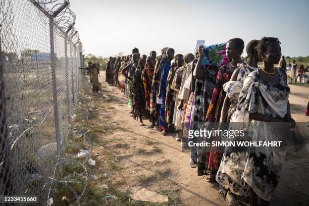 Women from Murle ethnic group wait in a line for a food distribution by United Nations World Food Programme in Gumuruk, South Sudan, on June 10 as...