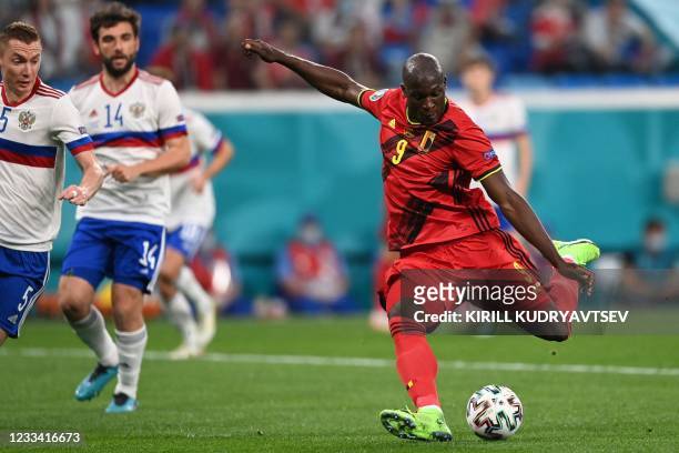 Belgium's forward Romelu Lukaku kicks the ball and scores his team's first goal during the UEFA EURO 2020 Group B football match between Belgium and...