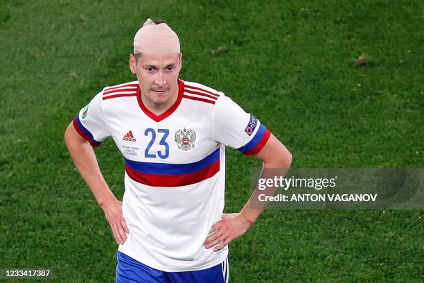 Russia's midfielder Daler Kuzyaev looks on as he leaves the pitch after a collision during the UEFA EURO 2020 Group B football match between Belgium...