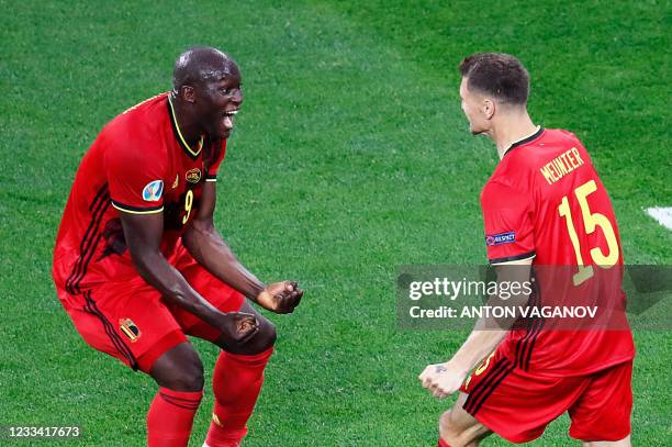 Belgium's defender Thomas Meunier celebrates with Belgium's forward Romelu Lukaku after scoring his team's second goal during the UEFA EURO 2020...