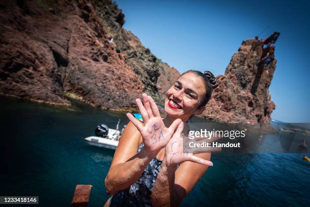 In this handout image provided by Red Bull, Jacqueline Valente of Brazil reacts after diving from the 21 metre platform during the final day of the...