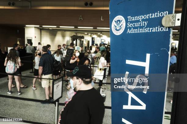 Travelers make their way through the Transportation Security Administration checkpoint at the Detroit Metropolitan Wayne County Airport in Romulus,...