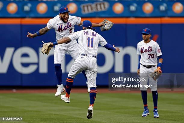 Dominic Smith of the New York Mets celebrates with Kevin Pillar of the New York Mets in front of Mason Williams of the New York Mets after defeating...