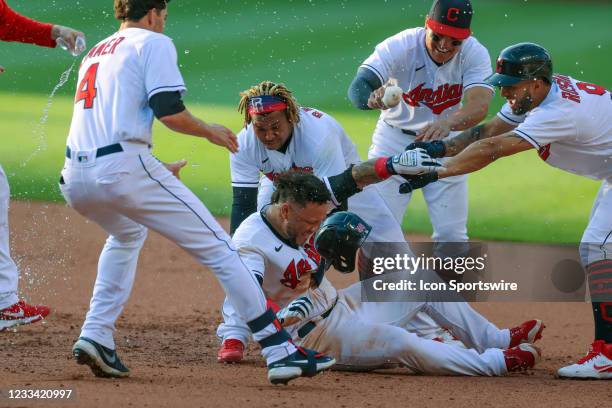 Cleveland Indians center fielder Harold Ramirez is mobbed by Cleveland Indians outfielder Bradley Zimmer , Cleveland Indians third baseman Jose...