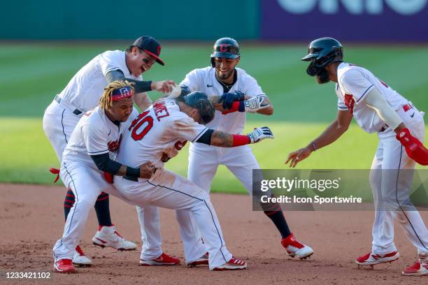 Cleveland Indians center fielder Harold Ramirez is mobbed by Cleveland Indians third baseman Jose Ramirez , Cleveland Indians infielder Yu Chang ,...