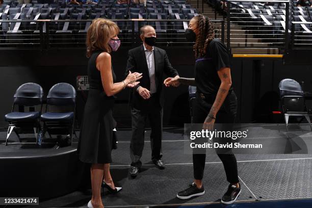 Former Minnesota Lynx player, Seimone Augustus talks with Minnesota Lynx owners, Glen and Becky Taylor before the game on June 12, 2021 at Target...