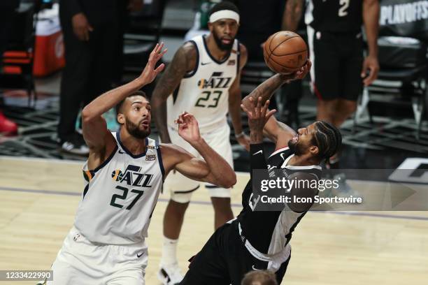 Clippers guard Paul George falls back for a shot during game 3 of the second round of the NBA Western Conference playoffs between the Utah Jazz and...