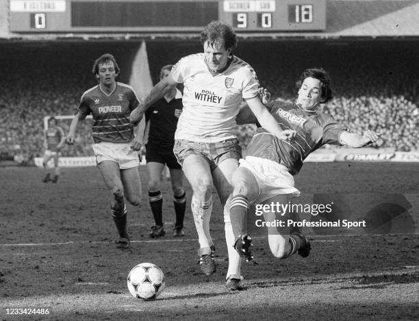 Mick Channon of Norwich City is tackled by George Burley of Ipswich Town during the Milk Cup Semi Final 1st Leg tie at Portman Road on February 23,...