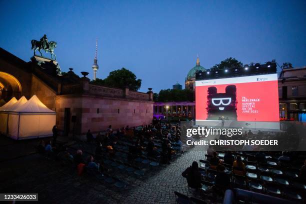 Spectators attend the premiere of the film 'Forest - I See You Everywhere' as part of the 'Berlinale Summer Special' film festival at the open air...