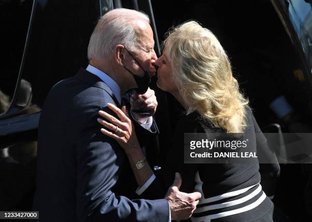 President Joe Biden and US First Lady Jill Biden share a kiss as they leave church after attending mass in St Ives, Cornwall during the G7 summit on...