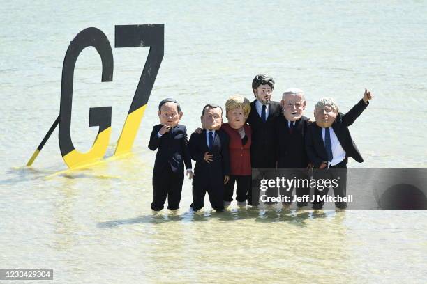 Extinction Rebellion environmental activists wearing masks of some of the G7 leaders, stage a demonstration during the G7 summit on June 13, 2021 in...