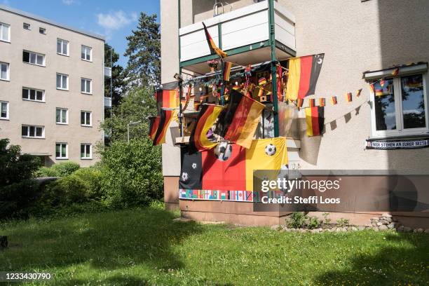 Balcony is decorated with German flags and banners as fans watch UEFA EURO 2020 in the Berlin district of Steglitz on June 13, 2021 in Berlin,...