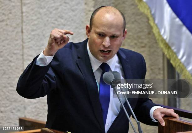 Head of Israel's right-wing Yamina party Naftali Bennett addresses lawmakers during a special session to vote on a new government at the Knesset in...