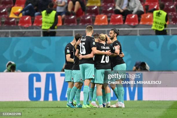 Austria's defender Stefan Lainer celebrates scoring the opening goal with his teammates during the UEFA EURO 2020 Group C football match between...