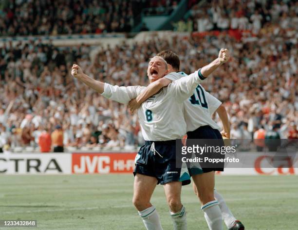 Paul Gascoigne of England celebrates after scoring with teammate Teddy Sheringham during the UEFA Euro 1996 Group A match between Scotland and...