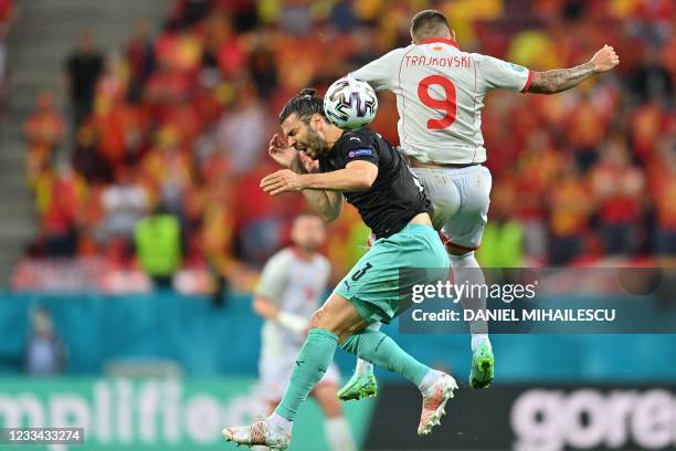 North Macedonia's forward Aleksandar Trajkovski and Austria's defender Aleksandar Dragovic collide during the UEFA EURO 2020 Group C football match...