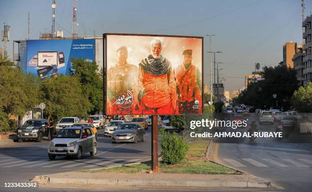 This picture taken on June 13, 2021 shows a view of a billboard depicting the late commander of the Iranian-backed Hashed al-Shaabi paramilitary...