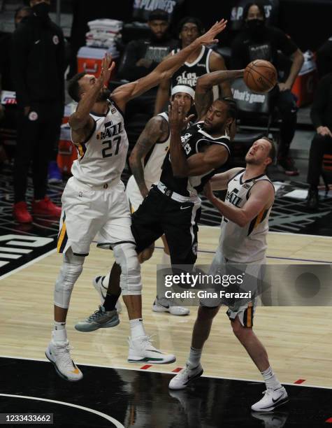 Clippers forward Kawhi Leonard passes off as hes double teamed by Utah Jazz center Rudy Gobert and Utah Jazz guard Joe Ingles in the second half of...