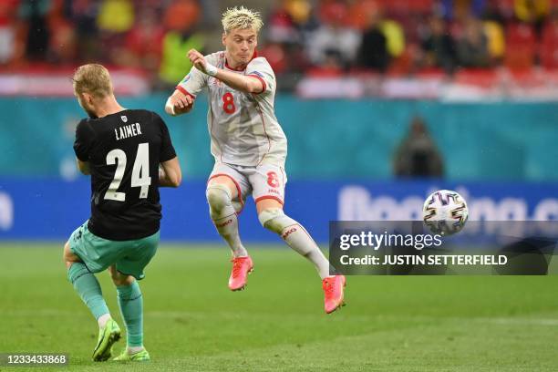 North Macedonia's defender Ezgjan Alioski challenges Austria's midfielder Konrad Laimer during the UEFA EURO 2020 Group C football match between...