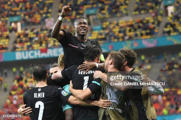 Austria's forward Michael Gregoritsch celebrates scoring his team's second goal with his team-mates including Austria's defender David Alaba during...