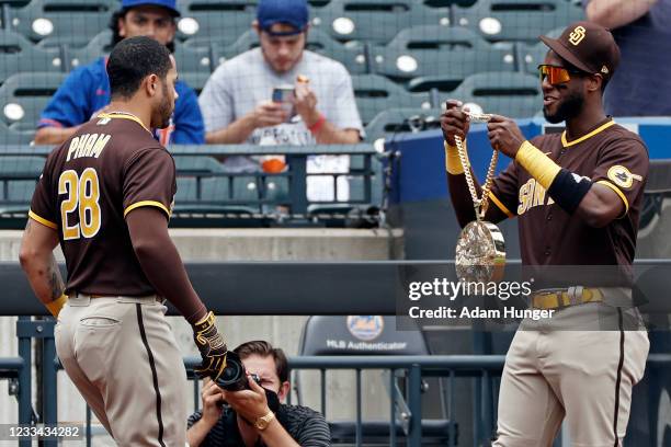 Tommy Pham of the San Diego Padres is given the Swag Chain from Jurickson Profar of the San Diego Padres after hitting a solo home run to lead off...