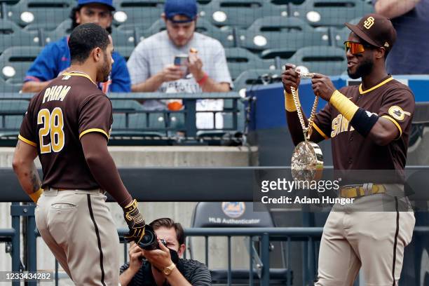 Tommy Pham of the San Diego Padres is given the Swag Chain from Jurickson Profar of the San Diego Padres after hitting a solo home run to lead off...