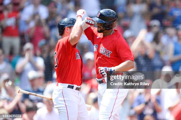 Xander Bogaerts celebrates with teammate Hunter Renfroe of the Boston Red Sox after hitting a solo home run in the second inning against the Toronto...