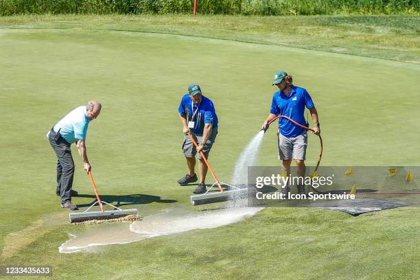 Grounds keepers make emergency repairs to a broken sprinkler on the seventh green minutes before the first group arrived during the final round of...