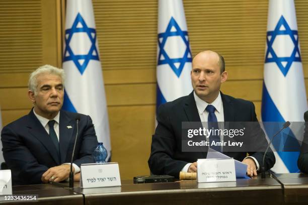 In coming Israeli Prime Minister Naftali Bennett and Foreign Minister Yair Lapid attend the first meeting of the new government on June 13, 2021 in...