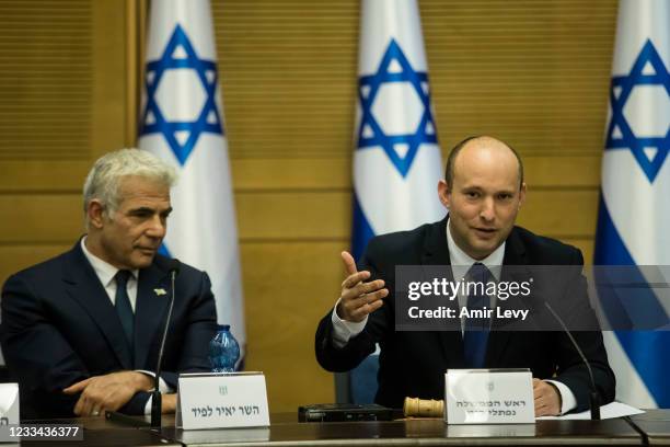 In coming Israeli Prime Minister Naftali Bennett and Foreign Minister Yair Lapid attend the first meeting of the new government on June 13, 2021 in...