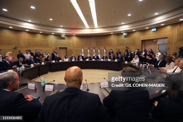 Members of Israel's new cabinet led by Naftali Bennett, Yair Lapid, Benny Gantz, Avigdor Lieberman, and others attend their first meeting at the...