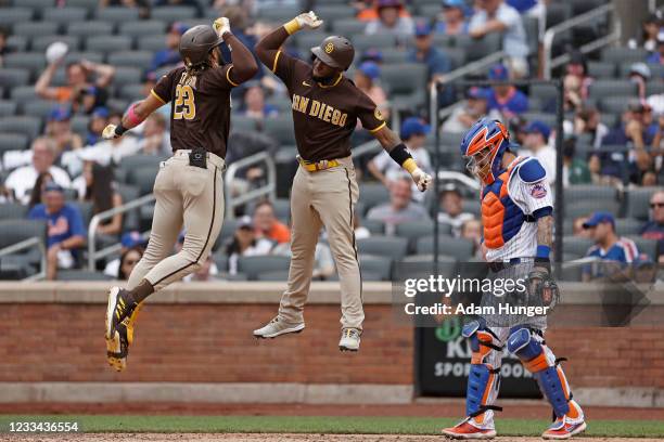 Fernando Tatis Jr. #23 of the San Diego Padres celebrates hitting a grand slam with Jurickson Profar of the San Diego Padres in front of Tomas Nido...