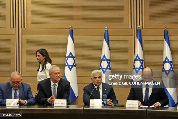 Israel's incoming Interior Minister Ayelet Shaked walks past incoming Prime Minister Naftali Bennett, Alternate Prime Minister and Foreign Minister...