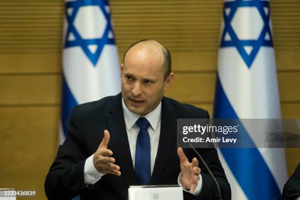 In coming Israeli Prime Minister Naftali Bennett attends the first meeting of the new government on June 13, 2021 in Jerusalem, Israel. The new...