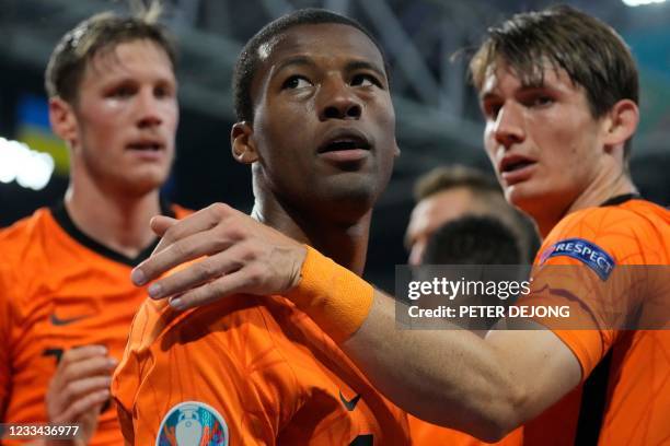 Netherlands' midfielder Georginio Wijnaldum celebrates with teammates after scoring the first goal during the UEFA EURO 2020 Group C football match...