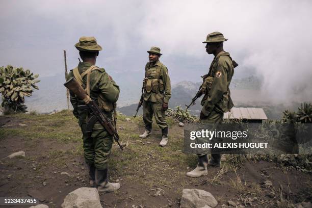 Rangers from the Virunga National Park rest on the slopes of the Nyiragongo volcano, north of Goma, the provincial capital of North Kivu, on June 11,...