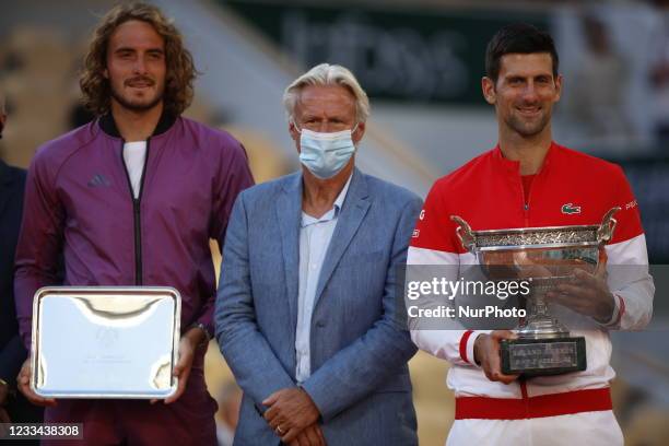 Novak Djokovic of Serbia embraces former tennis player Bjorn Borg as receives the trophy after winning his Men's Singles Final match against Stefanos...