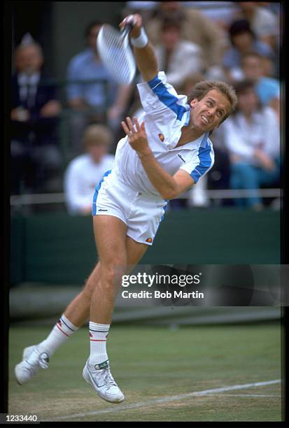 JOHN LLOYD OF GREAT BRITAIN MAKES A SERVE DURING A MATCH AT THE 1988 WIMBLEDON TENNIS CHAMPIONSHIPS.