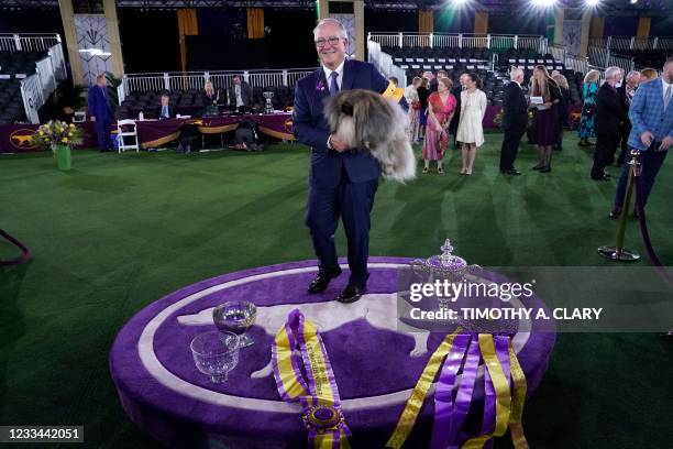 David Fitzpatrick with his Pekingese "Wasabi" are seen after winning Best in Show at the 145th Annual Westminster Kennel Club Dog Show June 13, 2021...