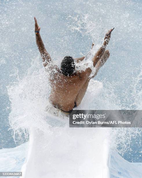 Jeff Farmer, former Melbourne Demons and Fremantle Dockers player, goes down the slide during Big Freeze 7 at the Melbourne Cricket Ground on June...