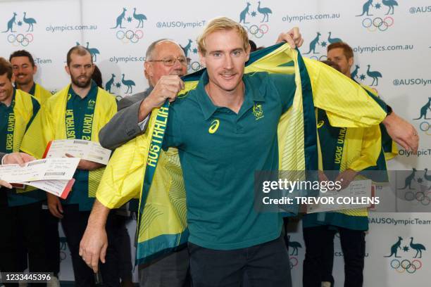 Aran Zelewski is presented with his team kimono by Hockey Australia official Pat Hall after being named a co-captain of the Australian men's hockey...